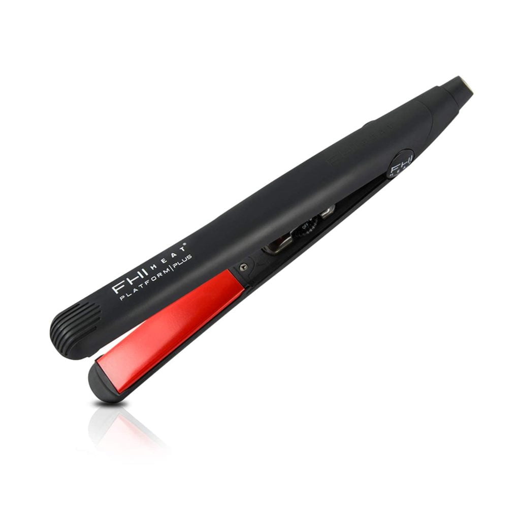 A black and red flat iron, displayed horizontally.