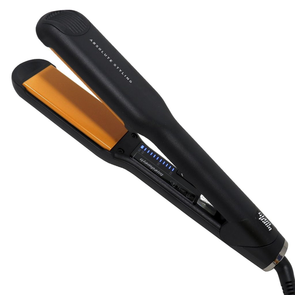 A close-up of a black flat iron with orange heating plates.