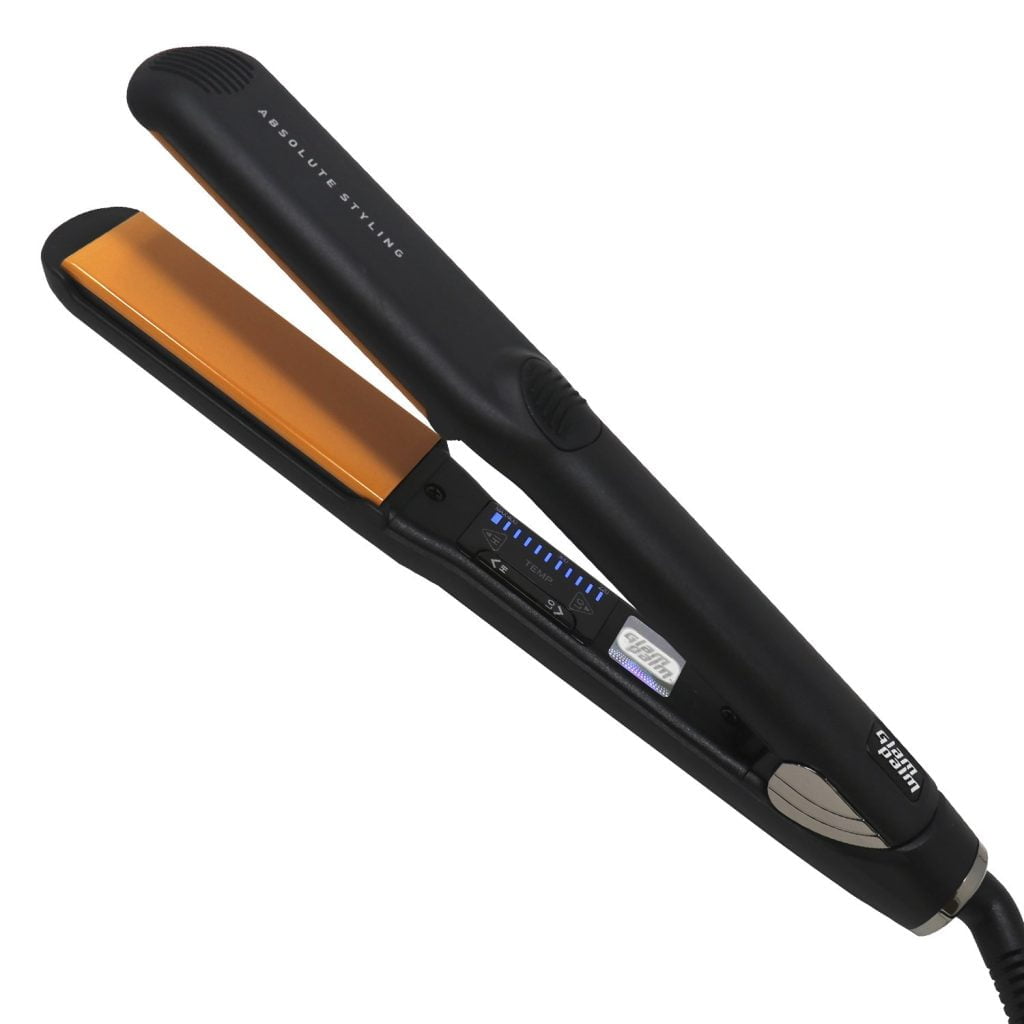 A close-up of a black flat iron with orange heating plates.