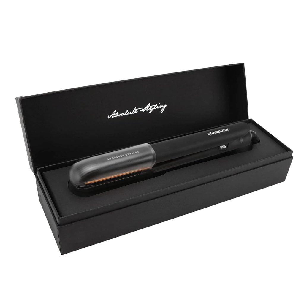 A black flat iron in its box with sleek packaging.