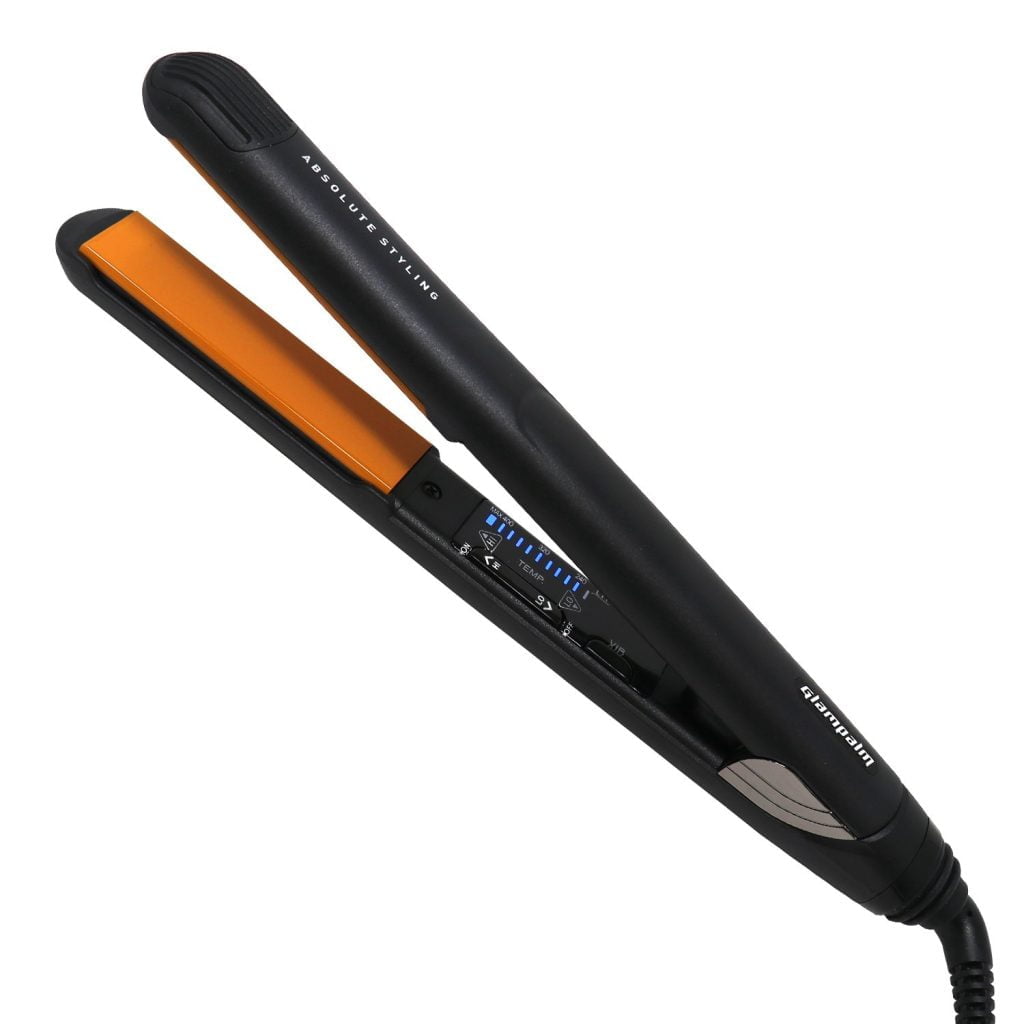 A close-up of the black flat iron with orange heating plates.