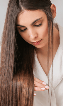 A close-up of a woman with long straight hair.