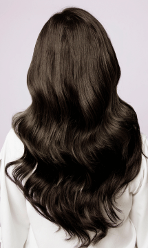 A close-up of long, wavy, shiny dark brown hair from behind.